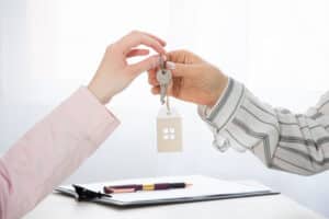 Transfer of house keys from the seller’s agent to the buyer’s client. Real estate
